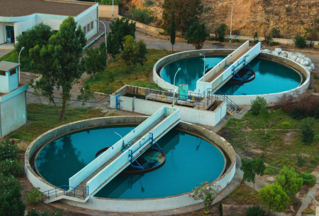 pexels-photo-5712211-5712211 Drone shot of an advanced water purification plant surrounded by trees.